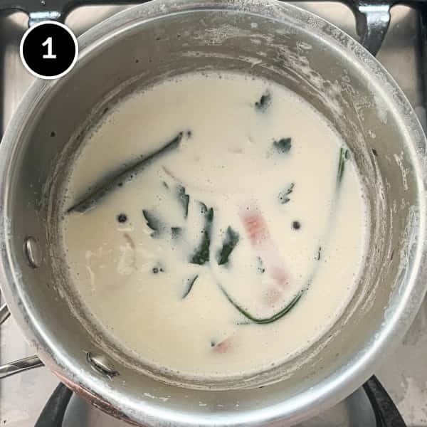 A pan with milk seasoned with shallots, pepper, cloves, bay leaves and parsley