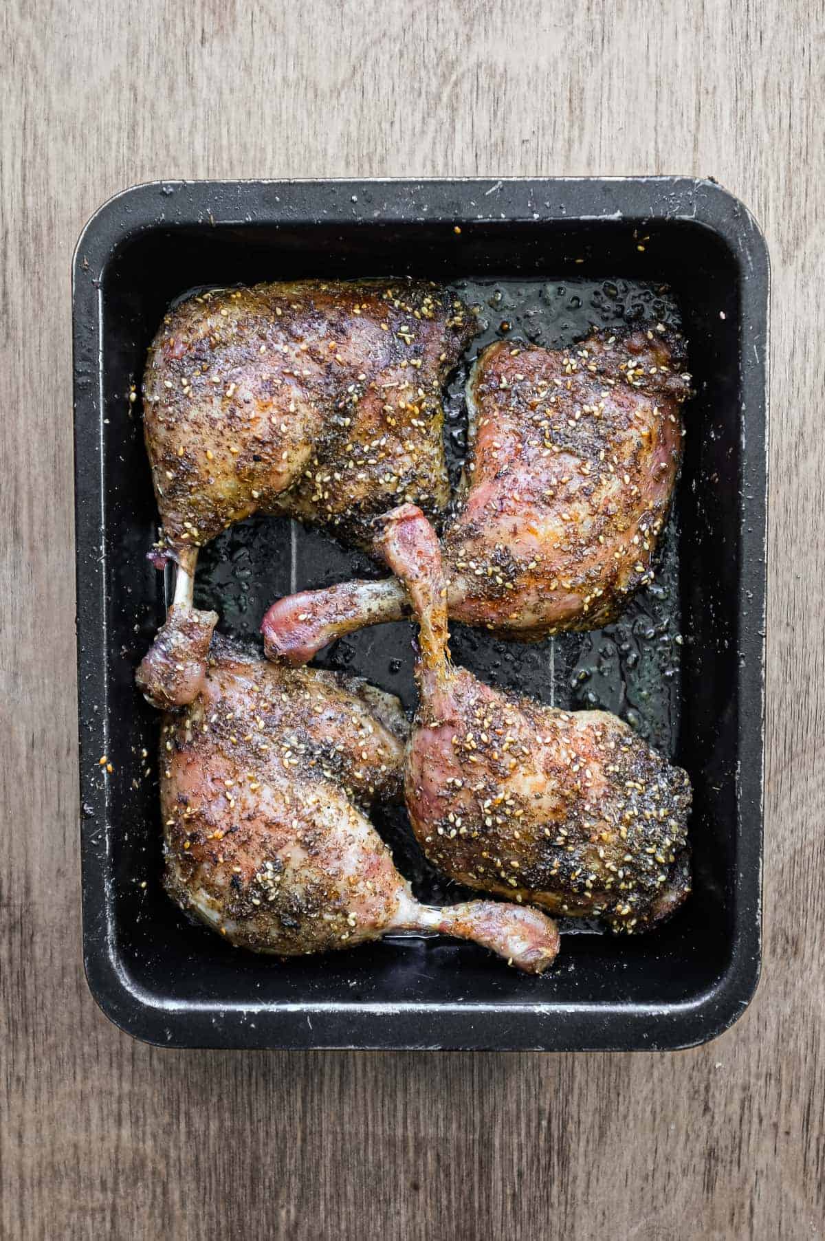 4 roasted duck legs with zaatar in a baking tin