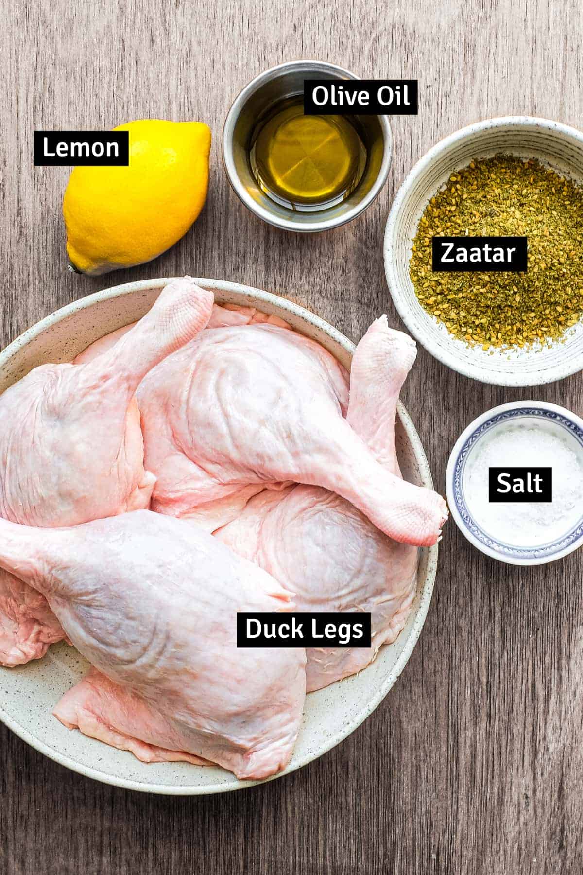 The ingredients for Roasted duck with zaatar: duck legs, zaatar spice mix, olive oil, salt and lemon