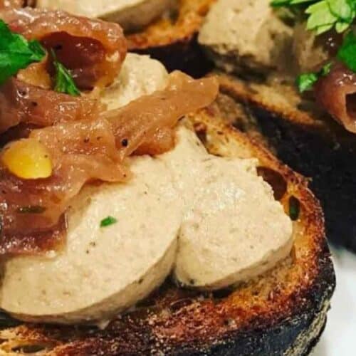 Rabbit liver pate spread on sourdough toast. Topped with caramelised onions and fresh parsley