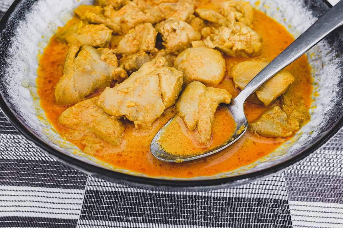 Chicken cooked in coconut milk with Malaysian aromatics to make Nyonya Chicken Curry (Ayam Kleo)