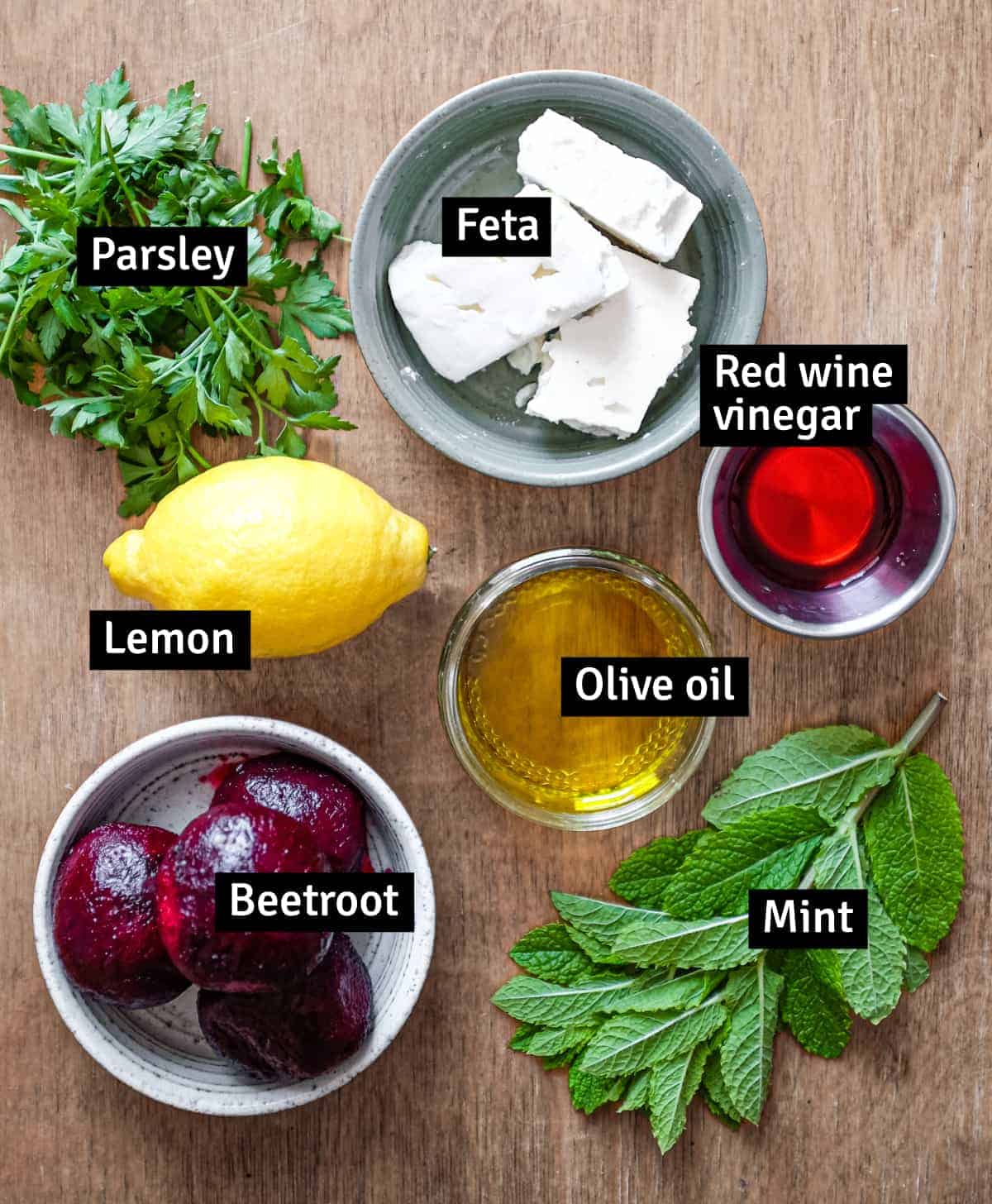 the ingredients for beetroot & Feta salad with her dressing: beetroot, lemon, red wine vinegar, olive oil, mint, parsley and feta cheese.