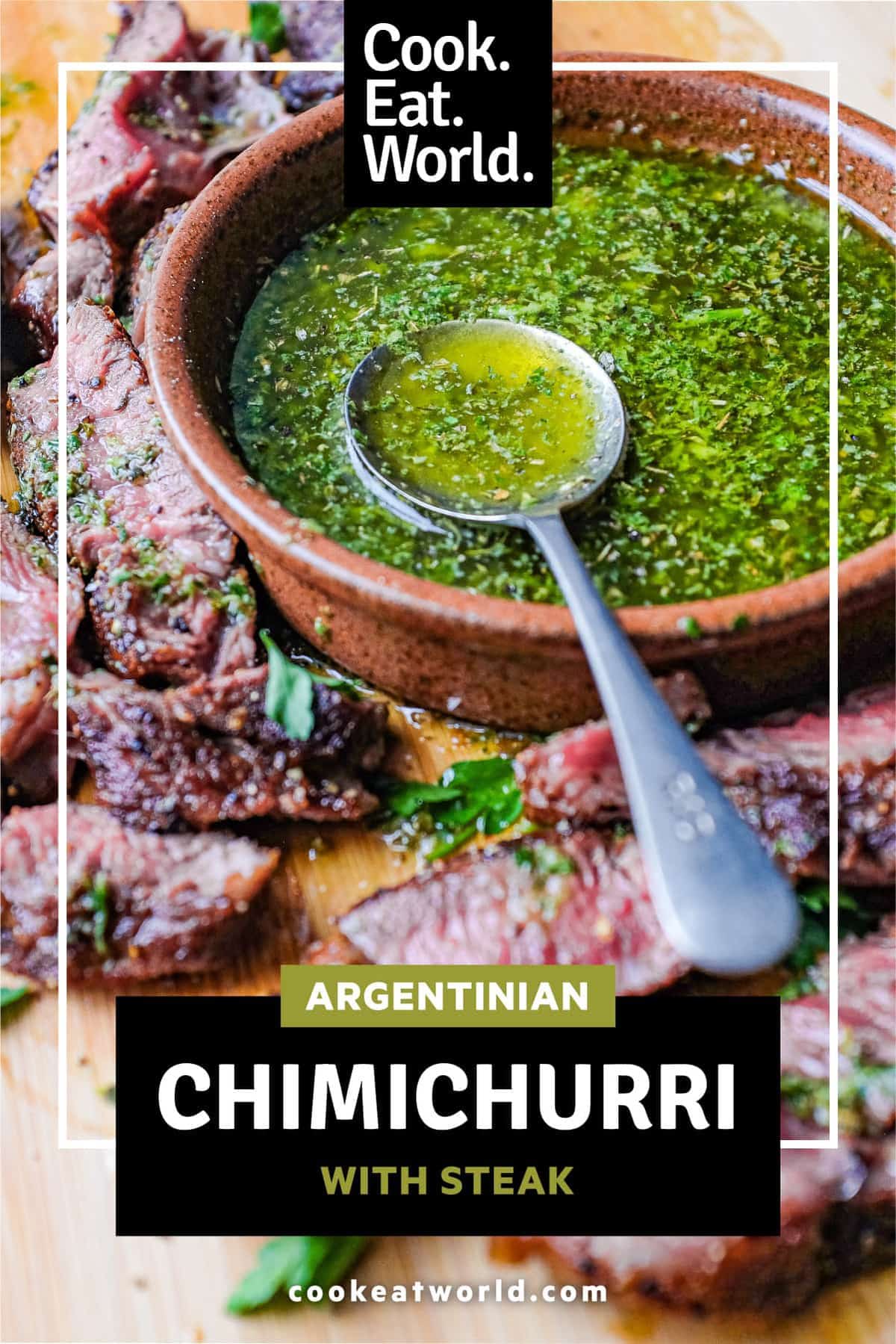 A small bowl of chimichurri sauce with a spoon sits alongside slices of rare cooked ribeye steak