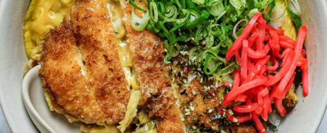 Chicken katsudon rice bowl with golden fried chicken, onion and soft egg