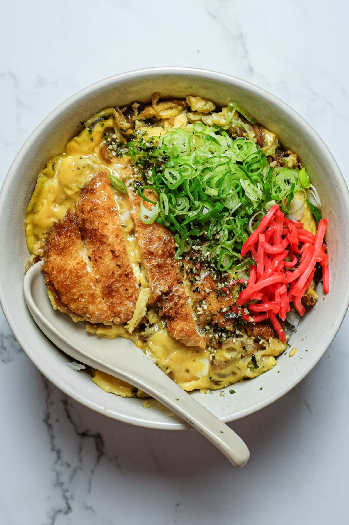 Chicken katsudon rice bowl with golden fried chicken, onion and soft egg
