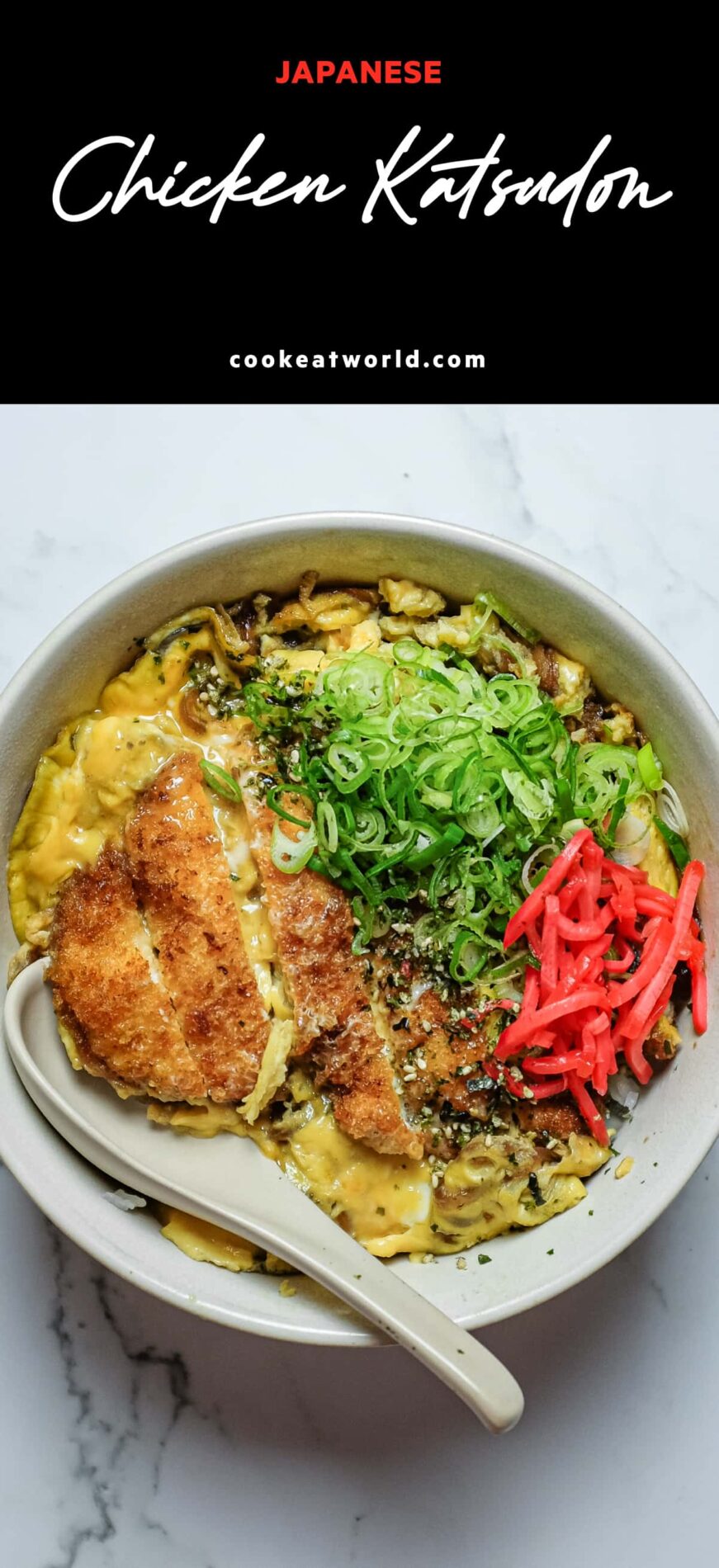 A bowl of chicken katsudon with sliced chicken katsu, softly cooked eggs and spring onions over steamed rice