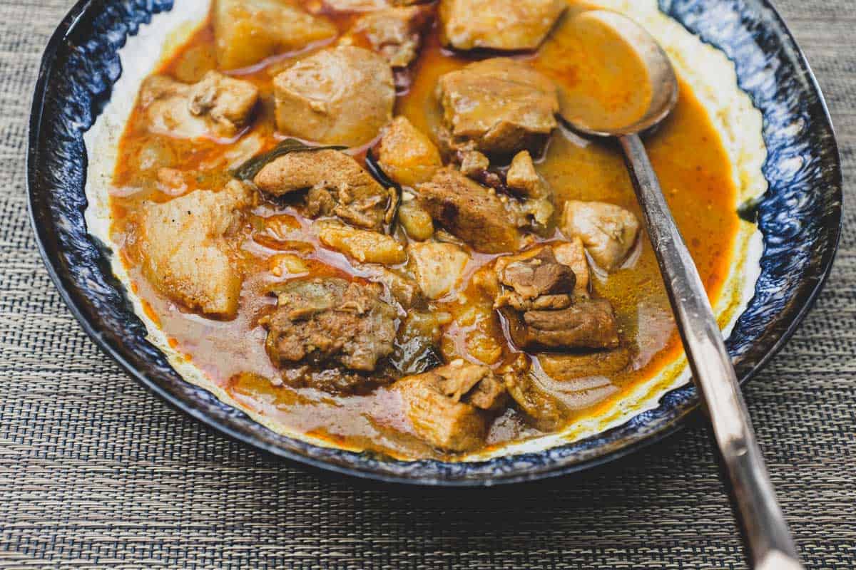 Malaysian Chicken Curry in a bowl with a spoon