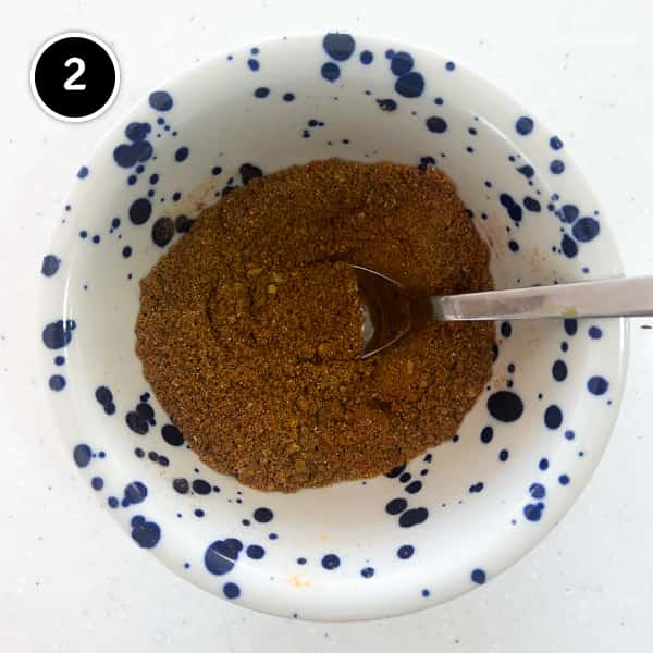 A fine curry powder in a small bowl.