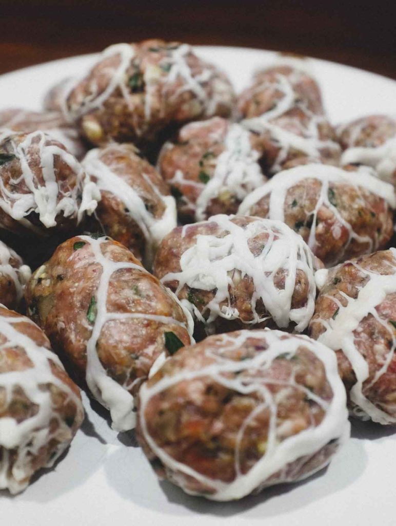 Lamb and pork meat rolled into small sausages and wrapped in caul fat