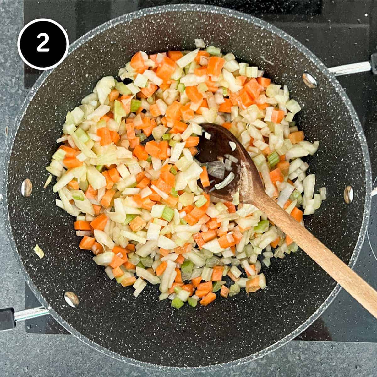 Onion, carrot and celery frying in a pan