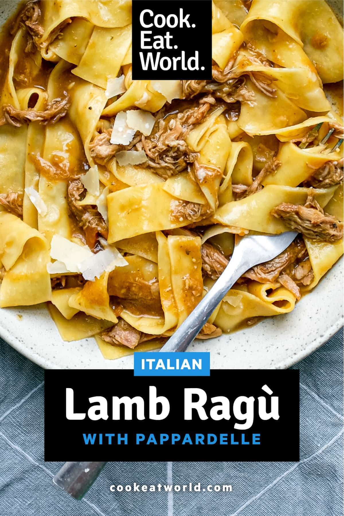 A bowl of pappardelle pasta with a lamb ragu sauce with a fork