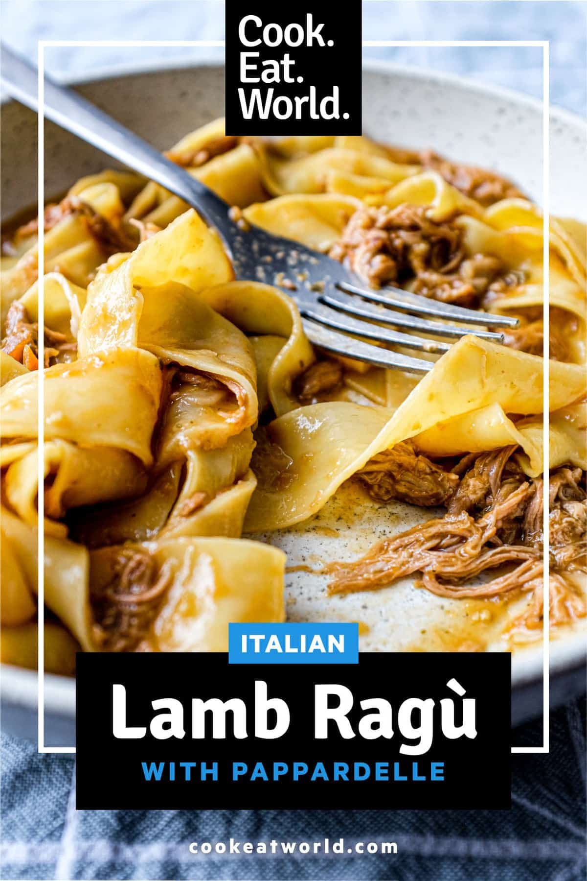 A bowl of pappardelle pasta with a lamb ragu sauce with a fork