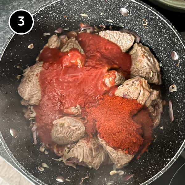 Pörkölt (Hungarian Beef Stew) | cookeatworld.com Tomatoes and Paprika being added to the Hungarian Pörkölt Beef Stew
