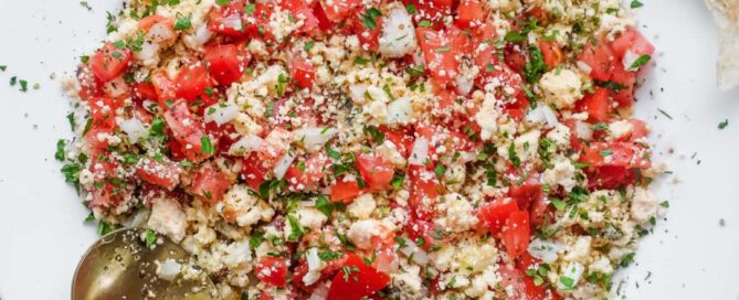 A bowl of Lebanese Shanklish Salad with a spoon