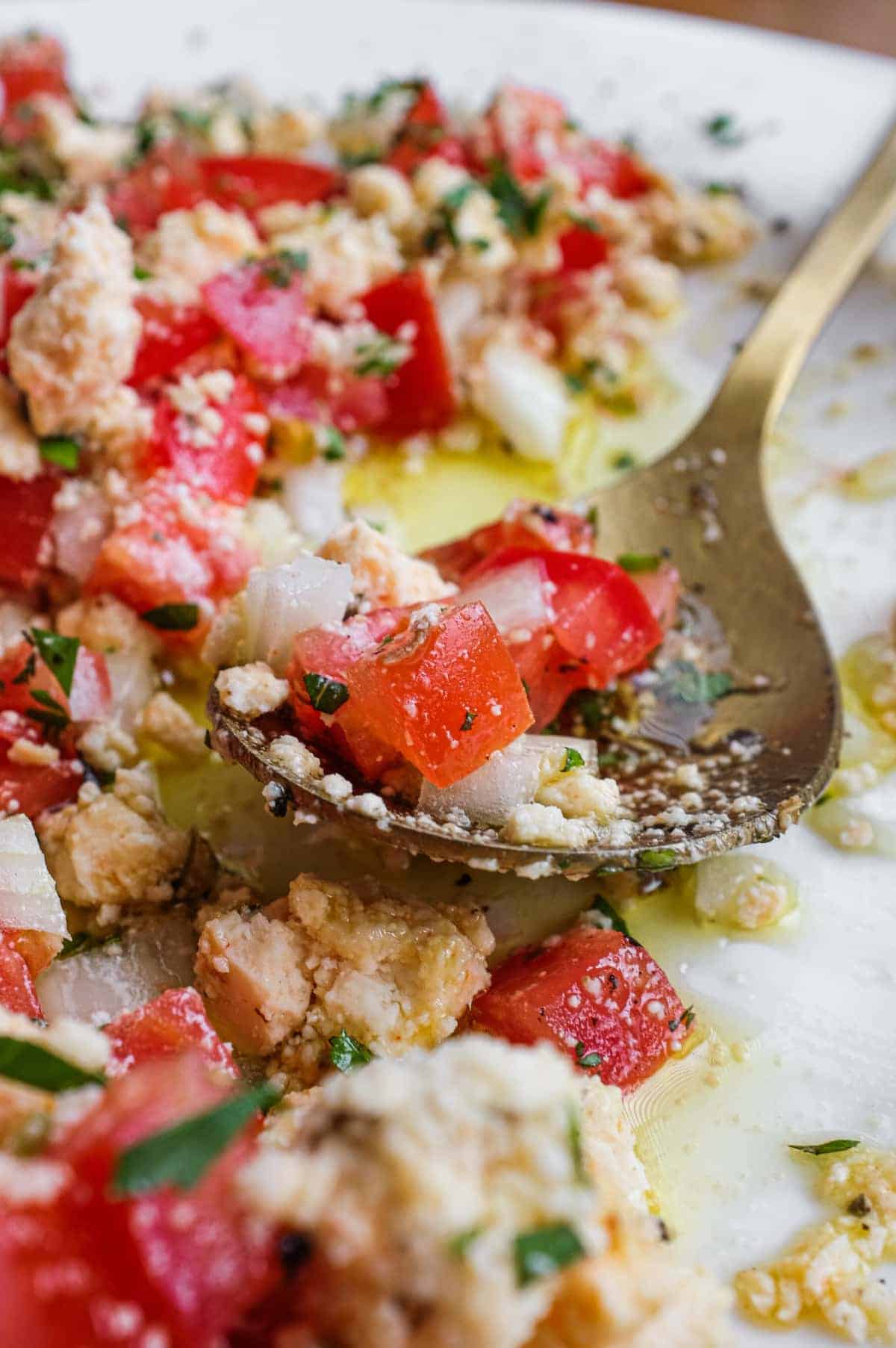 A bowl of Lebanese Shanklish Salad with a spoon