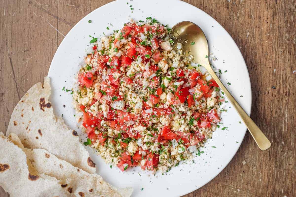 A bowl of Lebanese Shanklish Salad with a spoon