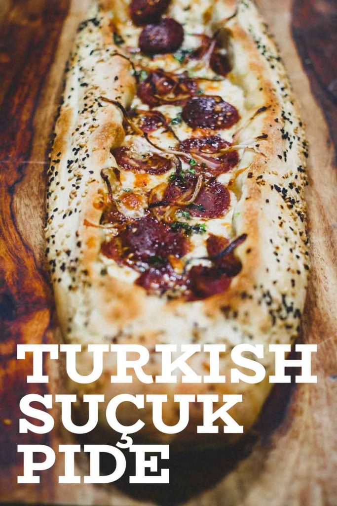 A whole Turkish Sucuk Pide on a wooden board