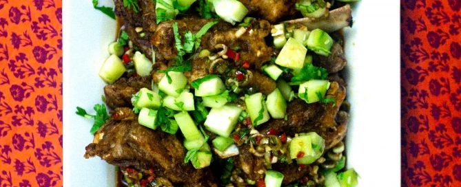 Shantung Lamb Ribs on a large platter on a red patterned background