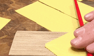 A square of pasta being shaped into a garganelli quill