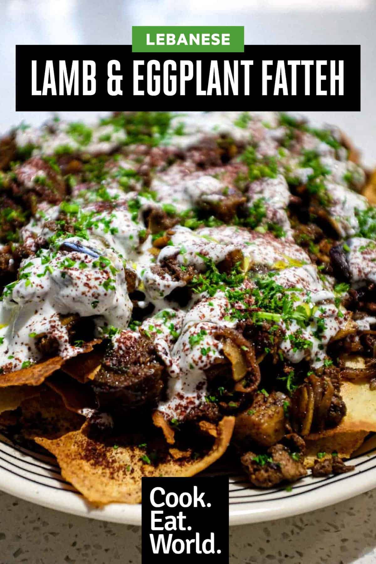 a platter of Lamb & Eggplant Fatteh garnished with fresh parsley and sumac