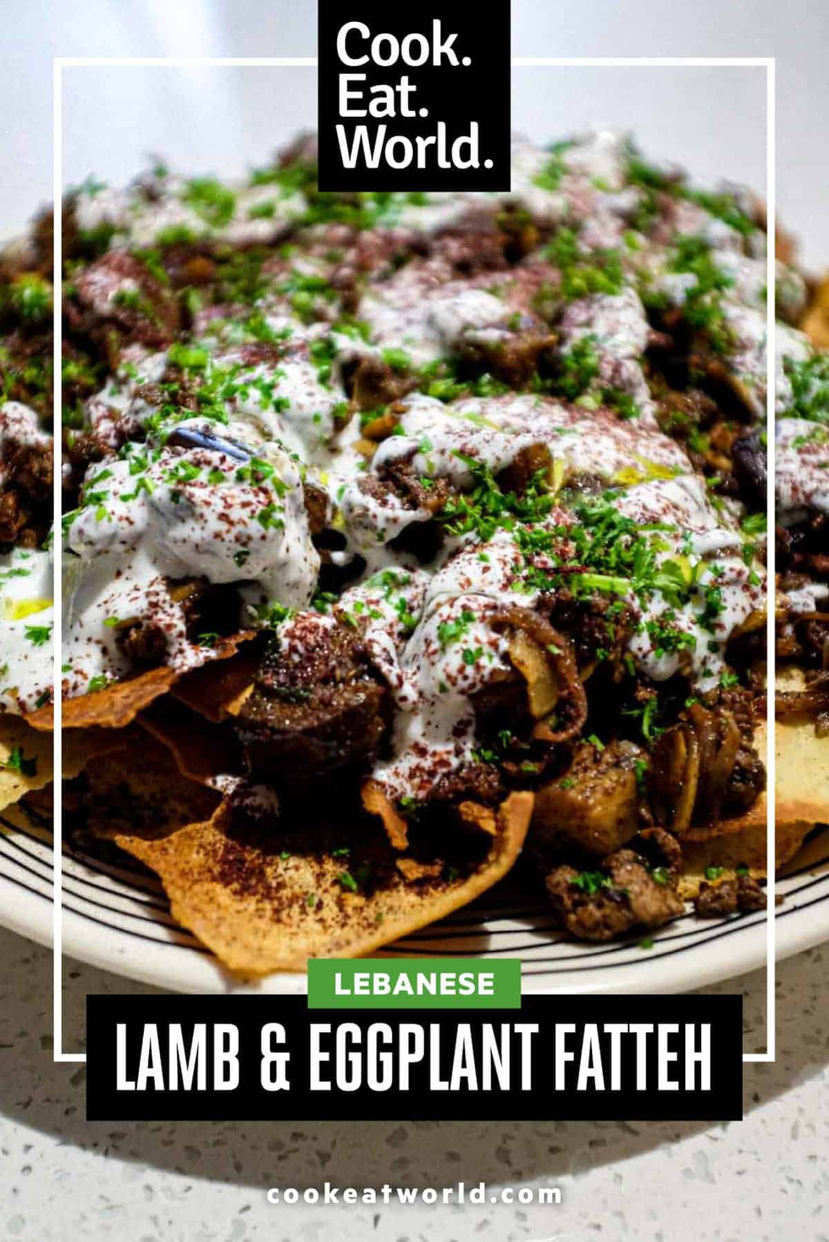 a platter of Lamb & Eggplant Fatteh garnished with fresh parsley and sumac