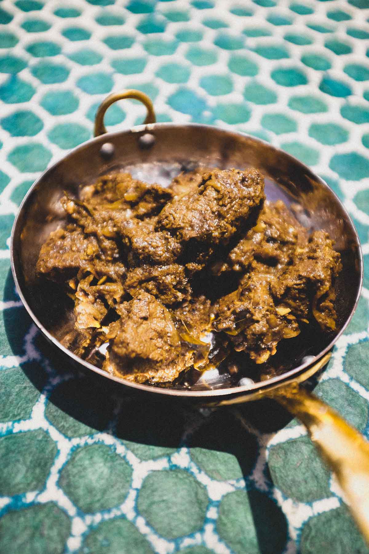A small copper balti pan holds a portion of Indian Beef Balti
