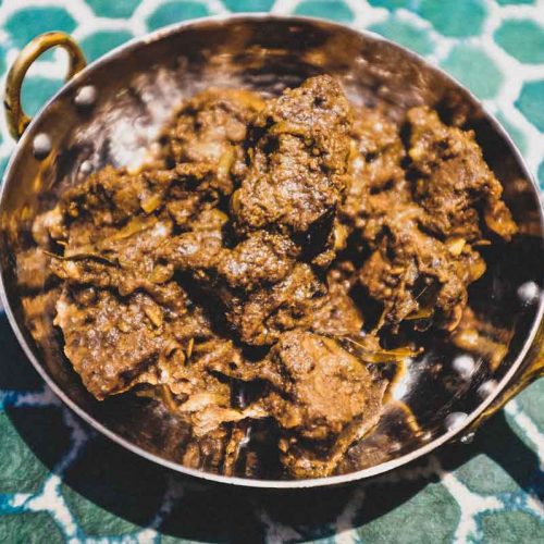 A small copper balti pan holds a portion of Indian Beef Balti