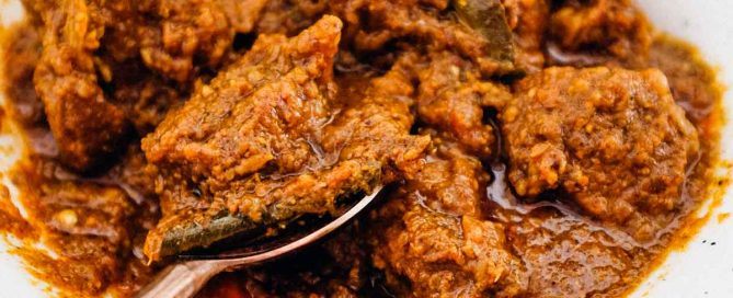 Bhuna Gosht a rich curry in a bowl with a spoon