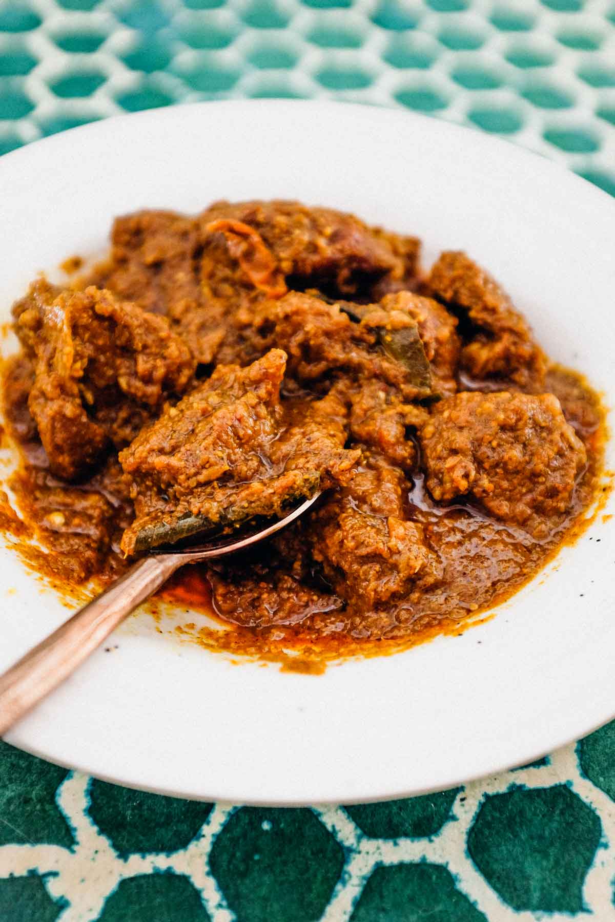 Bhuna Gosht a rich curry in a bowl with a spoon