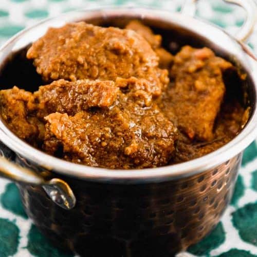 Bhuna Gosht Curry in a copper serving bowl