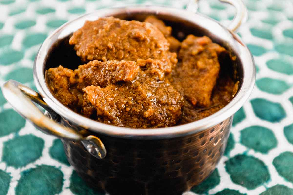 Bhuna Gosht Curry in a copper serving bowl