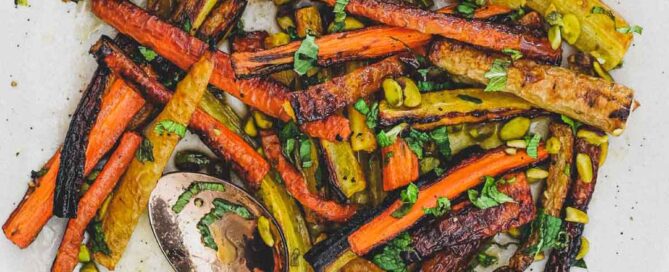 a platter of carrots with herbs