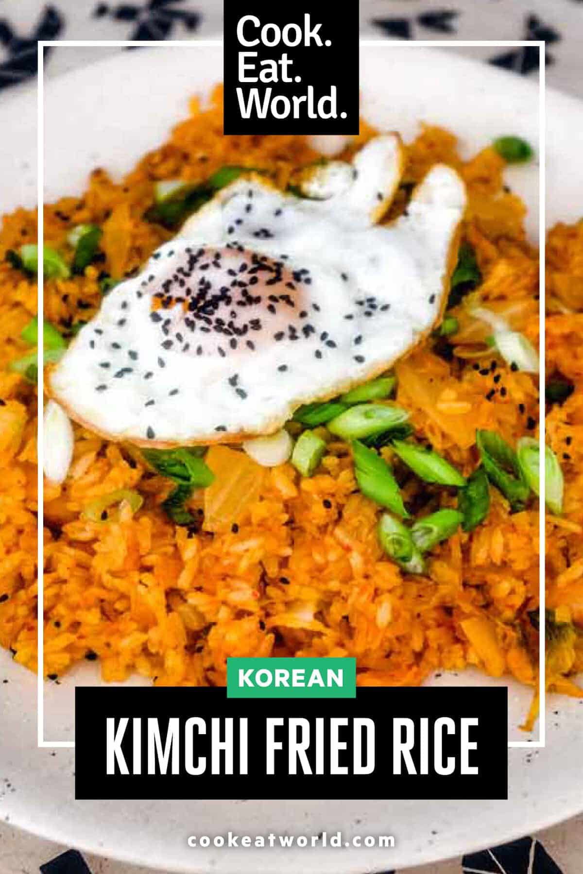 A plate of kimchi fried rice with a crisp fried egg on top scattered with spring onions