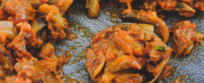 A platter of Spanish Eggplant Salad with a spoon
