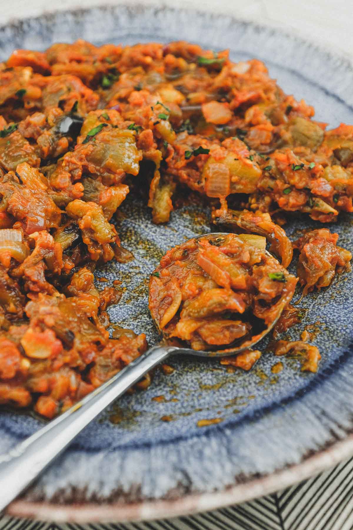 A platter of Spanish Eggplant Salad with a spoon