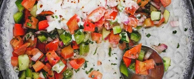 A bowl of turkish salad with a yoghurt dressing