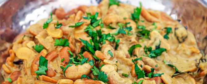 A silver bowl of cashew nut curry