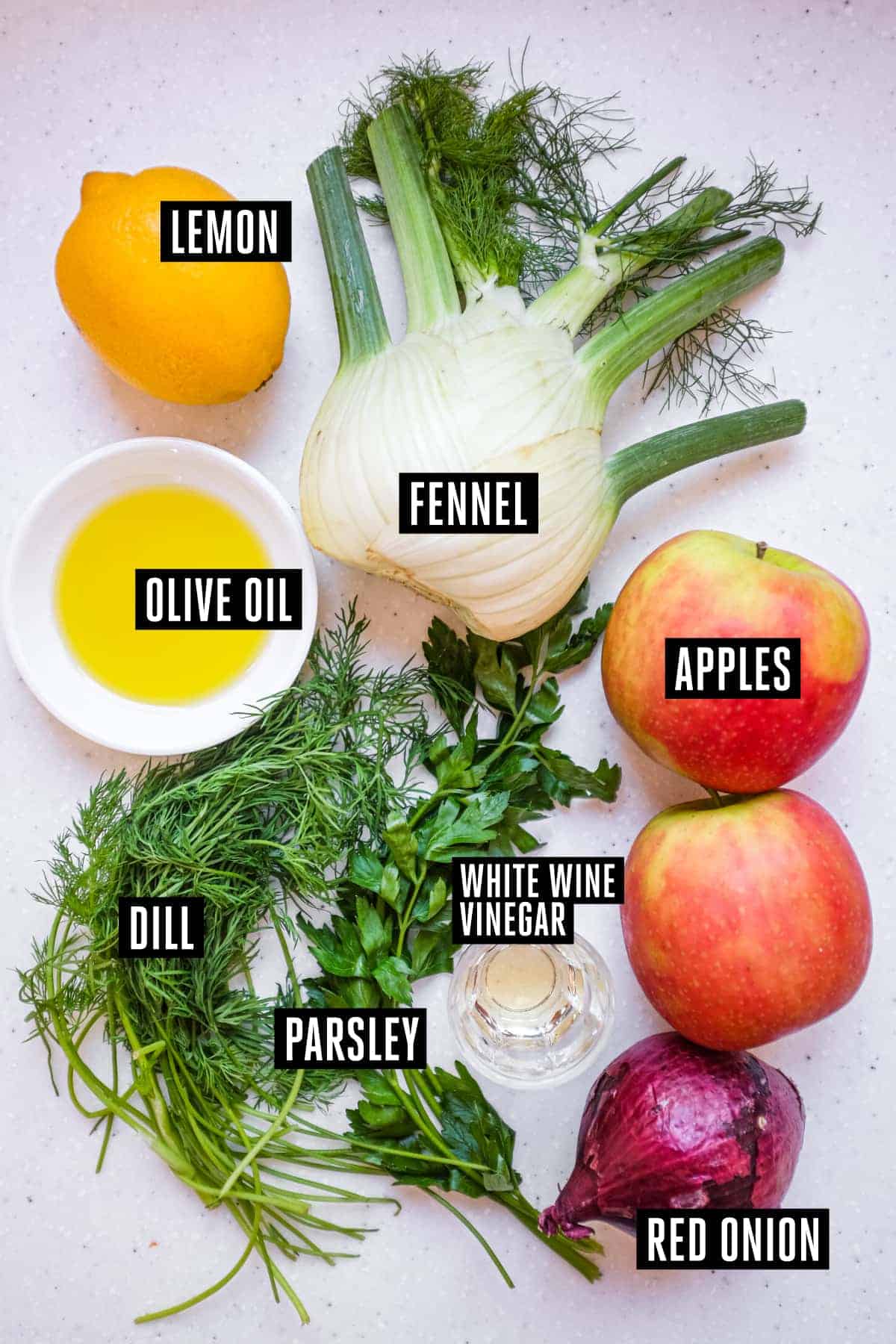 The ingredients for an Italian fennel and apple salad: Fennel, Apples, Red Onion, Parsley, Dill, Lemon, Vinegar and olive oil.