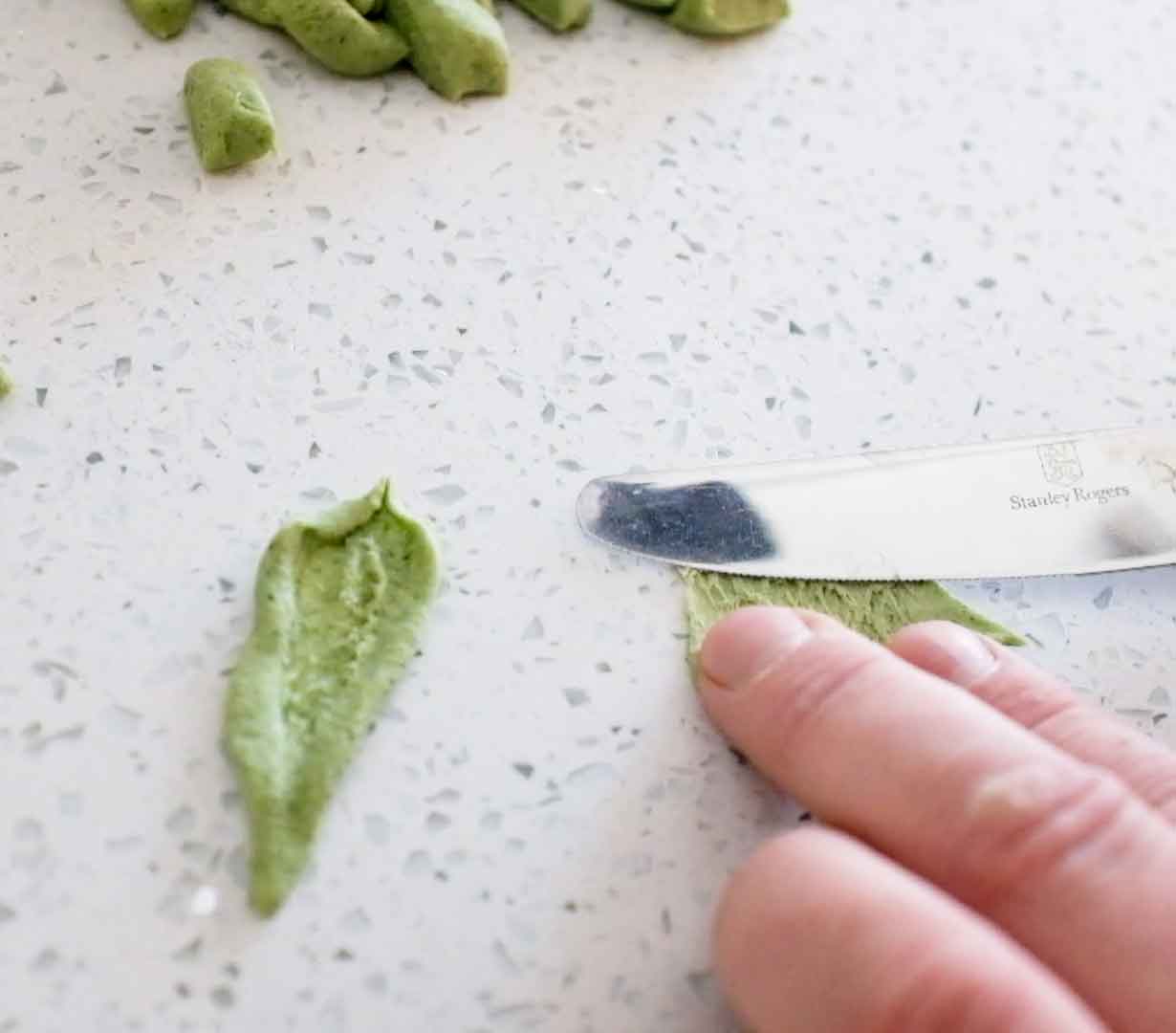 Pasta shapes made with spinach shaped into olive leaf shapes - foglie d'ulivo