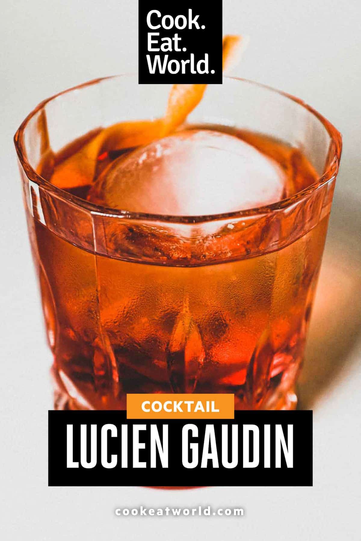 A glass of Lucien Gaudin cocktail with ice and a twist of lemon