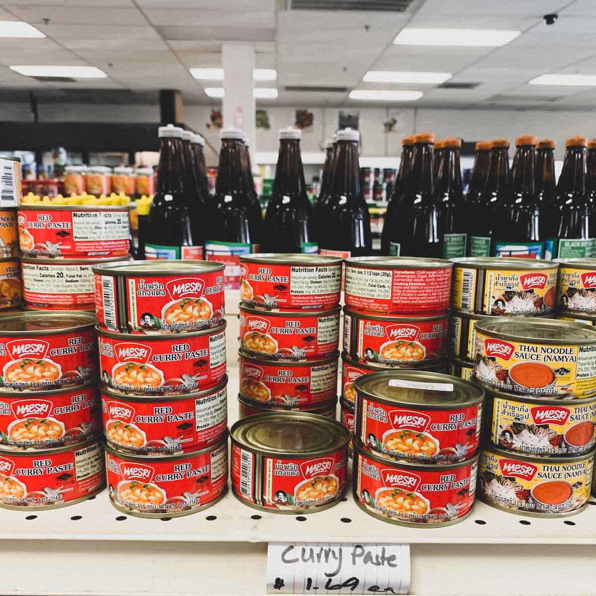 Cans of various curry pastes in a Laotian supermarket in the US