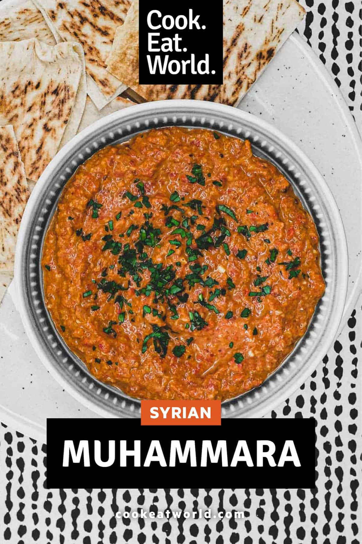 A bowl of Syrian Muhammara red pepper dip with flatbreads