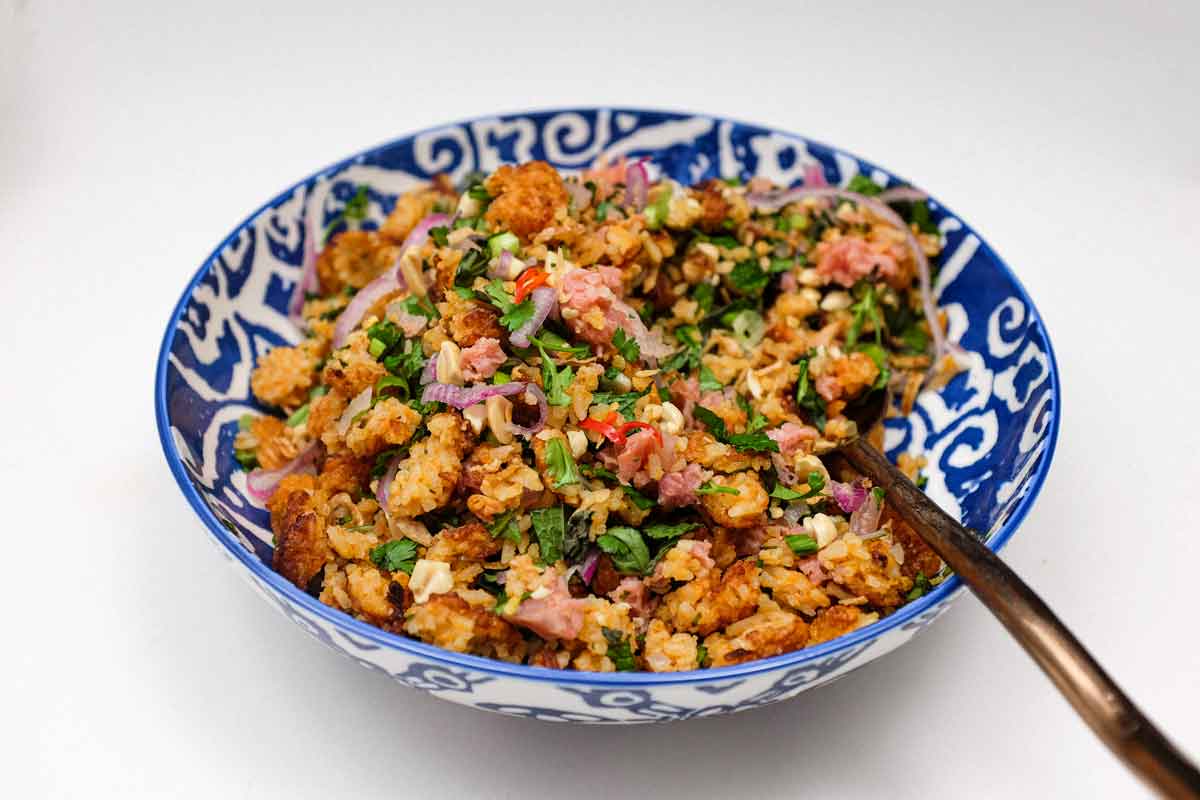A bowl of Laotian Nam Khao crispy rice salad