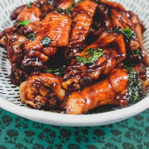 San Bei Ji chicken wings coated in sticky dark sauce with garlic and ginger