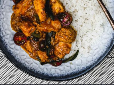 A bowl of chicken chukka curry with rice.