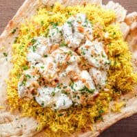 Close up of Jordanian lamb mansaf with rice, nuts and herbs