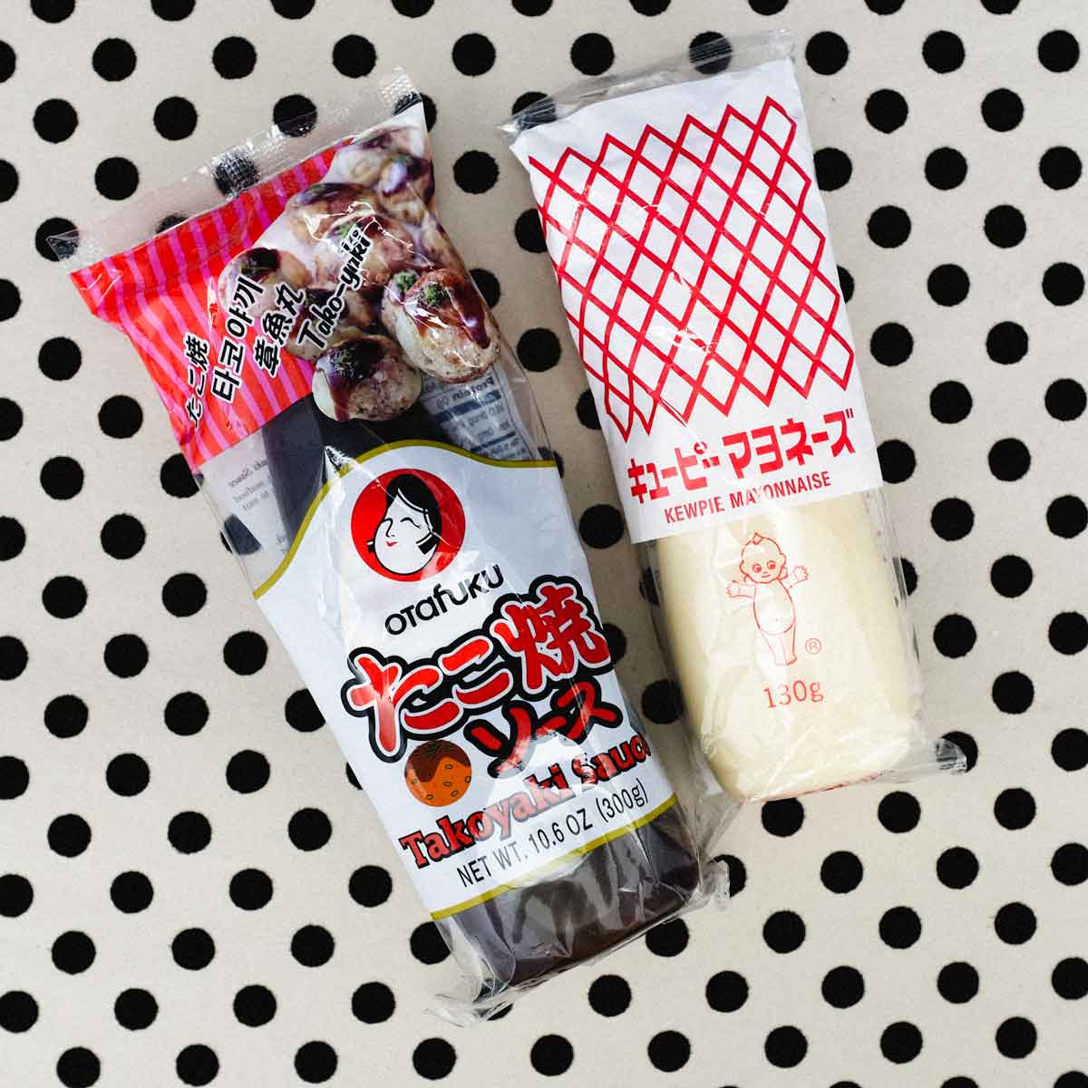 Japanese takoyaki sauce and kewpie mayonnaise on a polka dot background.