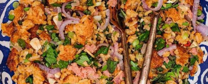 A bowl of Laotian Nam Khao crispy rice salad