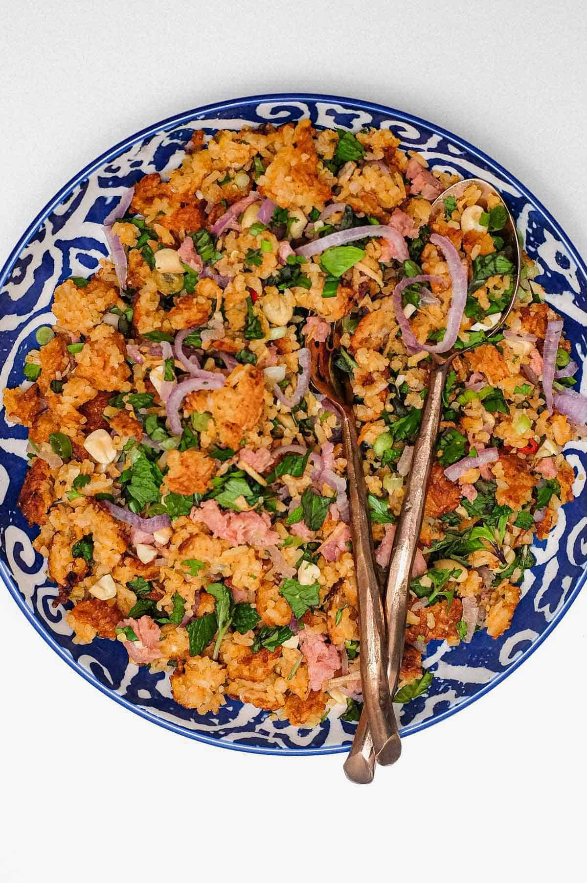 A bowl of Laotian Nam Khao crispy rice salad