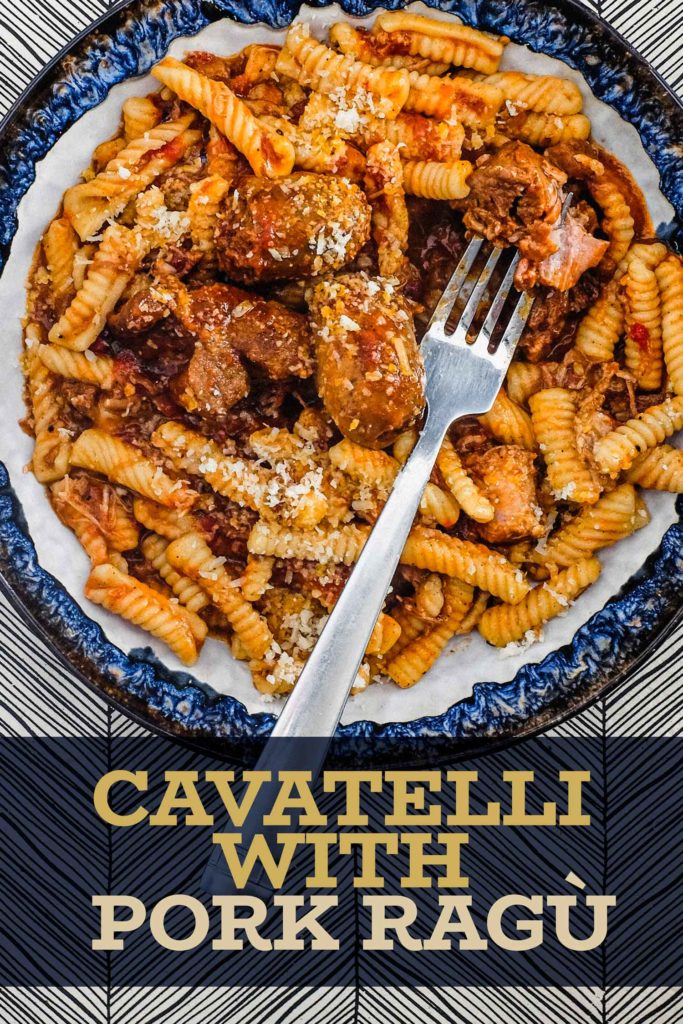 A bowl of cavatelli pasta with pork rag&ugrave; with a fork